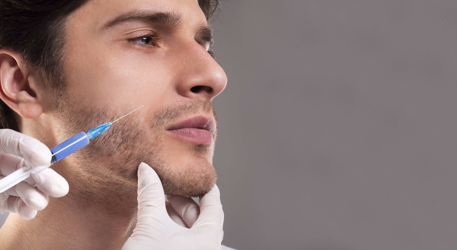 Male patient receiving facial aesthetic treatment